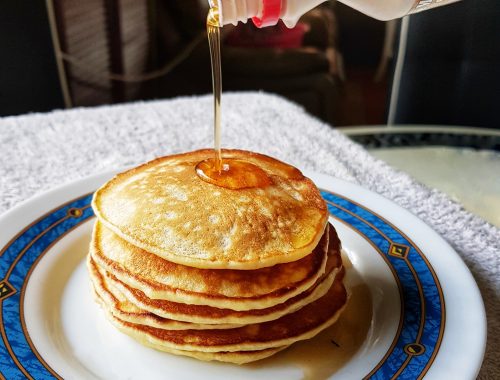 warm pancakes drizzled with maple syrup