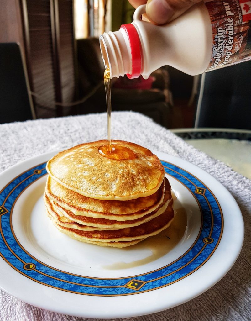warm fluffy pancakes drizzled with maple syrup
